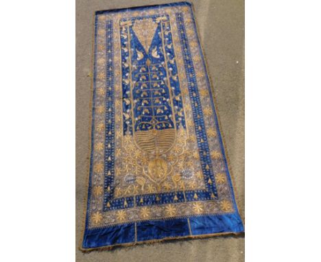 An Ethiopian velvet and gilt threaded hanging wall tapestry, depicting flowers and birds, 253cm x 118cm. 