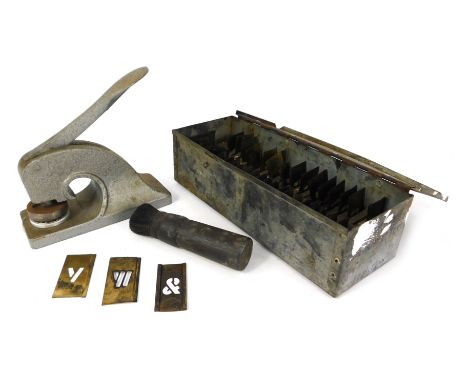 A vintage stainless steel letter press and various letter stamps. (2) 