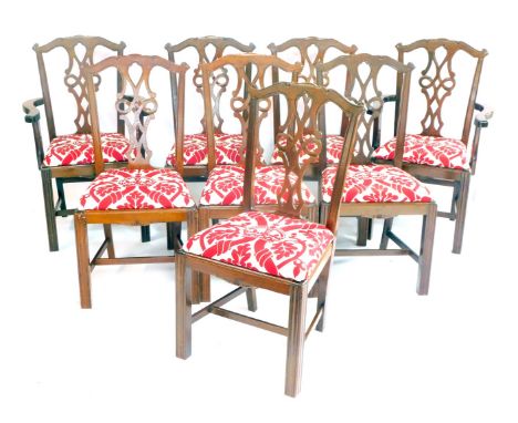 A set of eight Chippendale style mahogany dining chairs, with red and white fabric drop in seats decorated with crowns and oa