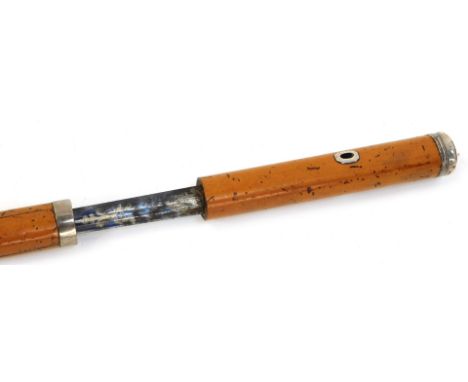 A Georgian malacca sword stick, with white metal knop and handle loop, part blued and gilt blade, with GR cipher under crown,