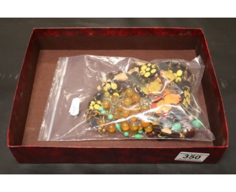 A collection of bakelite, celluloid and plastic jewellery to include 1920s grape design necklace, Art Deco bakelite fringe ne