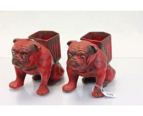 Pair of ceramic planters in the form of seated dogs with glass eyes and with a Red finish