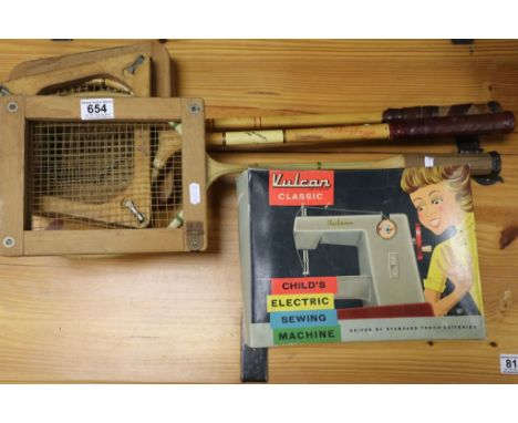 A child's Vulcan classic sewing machine, boxed, together with 2 vintage squash rackets and a vintage badminton racket (4)