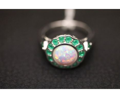 A silver ring with large centre opal