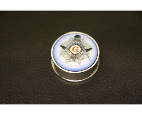 A silver and enamel lidded pill box with Masonic symbol