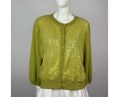 Delightful button up green cardigan decorated on the front with sequins and featuring shoulder pads. St John tag on neck, on 