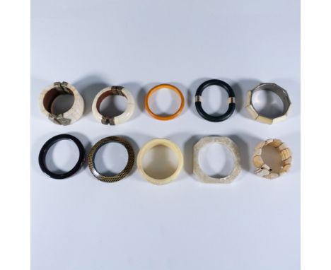 This collection features a variety of bangle-type bracelets, including an adjustable cuff and two hinged designs. The largest