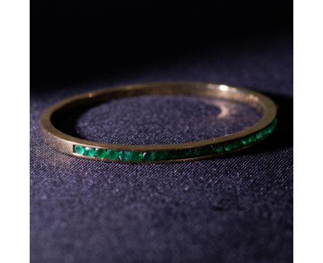 Stunning bangle bracelet in 18K gold with 1.50ct emeralds. Measures 2.25" x 2" inside when closed. Weight 20.20 grams. Note: 