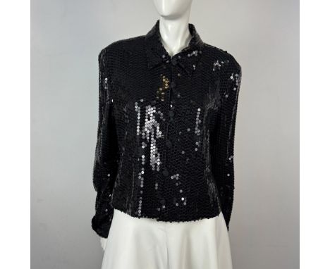 Short wasted, long sleeved, button front jacket embellished with black sequins. Jacket is lined and has cuffed sleeves. Dana 