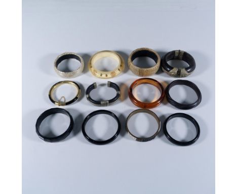 This collection features a variety of bangle-type bracelets, including an adjustable cuff and two hinged designs. The largest