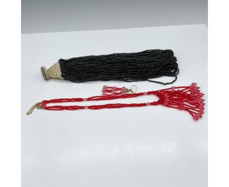 Lot includes black multistrand beaded necklace with macrame button closure (21"L) and raspberry colored art glass beaded neck