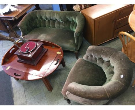 An upholstered button back settee and armchair