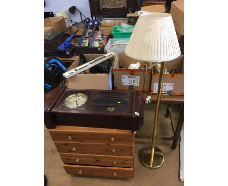 A pine chest of drawers, a clock and two lamps