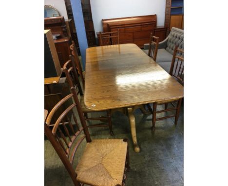 A light oak twin pedestal dining table with a set of six single country style chairs