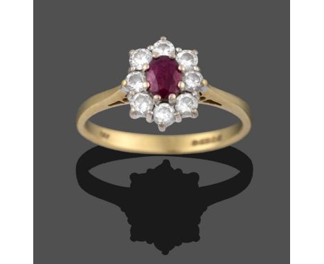 An 18 Carat Gold Ruby and Diamond Cluster Ring, an oval cut ruby within a border of round brilliant cut diamonds, in white cl