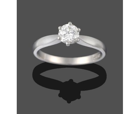 A Platinum Diamond Solitaire Ring, a round brilliant cut diamond in a claw setting, to knife edge shoulders, estimated diamon