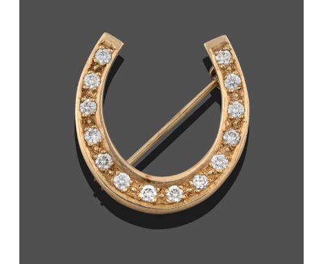 A 9 Carat Gold Diamond Horseshoe Brooch, the horseshoe motif set throughout with round brilliant cut diamonds in yellow claw 