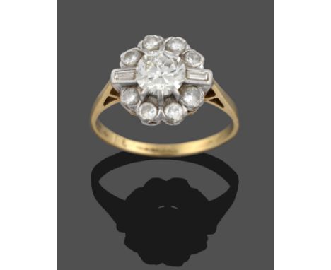 A Diamond Cluster Ring, a central round brilliant cut diamond within a border of smaller round brilliant cut diamonds, in whi