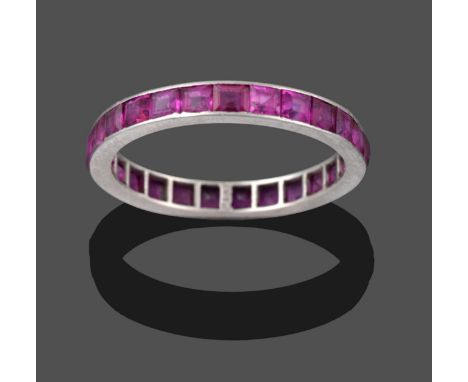 A Ruby Eternity Ring, the step cut rubies in a white flat sided shank, finger size L1/2 see illustration .  The ring is in go