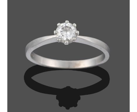 A Platinum Diamond Solitaire Ring, the round brilliant cut diamond in a claw setting to a tapered shoulder plain polished sha