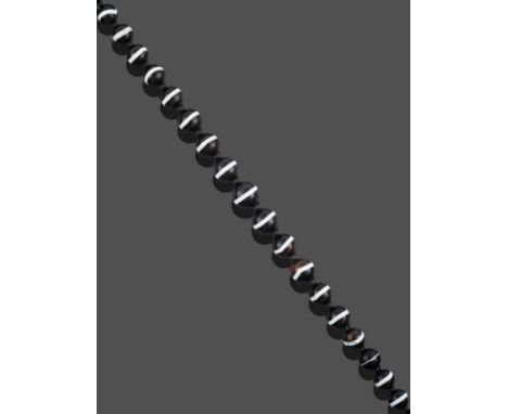 A Sardonyx Necklace, thirty-three graduated spherical sardonyx beads spaced by smaller black beads, length 58cm see illustrat