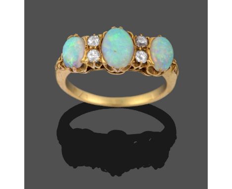 An Opal and Diamond Ring, three graduated oval cabochon opals spaced by pairs of old cut diamonds in yellow claw settings, to