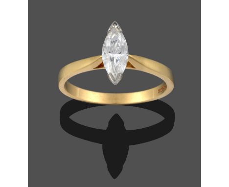 An 18 Carat Gold Diamond Solitaire Ring, the marquise cut diamond in a white claw setting, to a yellow tapered shoulder plain