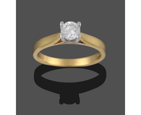 An 18 Carat Gold Diamond Solitaire Ring, a round brilliant cut diamond in a white claw setting, to a yellow tapered shoulder 