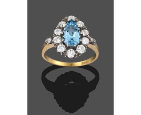 An Aquamarine and Diamond Cluster Ring, the central pear cut aquamarine within a border of round brilliant cut diamonds in wh