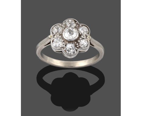 A Diamond Cluster Ring, seven old cut diamonds in white millegrain settings, to a tapered shoulder plain polished shank, tota