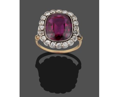 A Synthetic Ruby and Diamond Cluster Ring, a cushion cut synthetic ruby within a border of old cut diamonds in white rubbed o