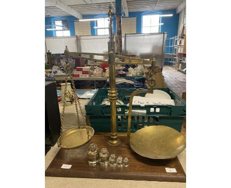 A unusual large set of brass scales on a wooden plinth, complete with glass weights.  No shipping 