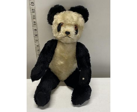 A vintage plush panda by Tywford with growler. 