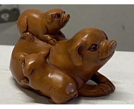 A boxwood netsuke with pig detail. Signed to base. 