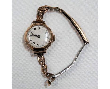 9ct gold cased ladies manual wind wristwatch, the silvered 22mm circular dial with black Arabic Numerals, with fifteen jewel 