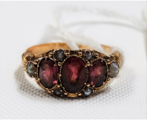 Victorian 15ct gold pink stone &amp; pearl set ring, the largest oval cut ruby of 0.50ct spread approx &amp; surrounded by si