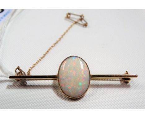 Good 9ct oval white opal set bar brooch, the opal measures 17 x 13mm approx &amp; shows colours of yellow, green, pink, purpl