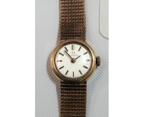 9ct gold ladies Omega bracelet manual-wind wristwatch, the circular silvered 12mm dial with gilt baton markers, weight overal
