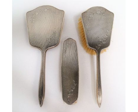 Modern silver engine turned and forget-me-not engraved three piece dressing table set, comprising mirror, clothes and hair br
