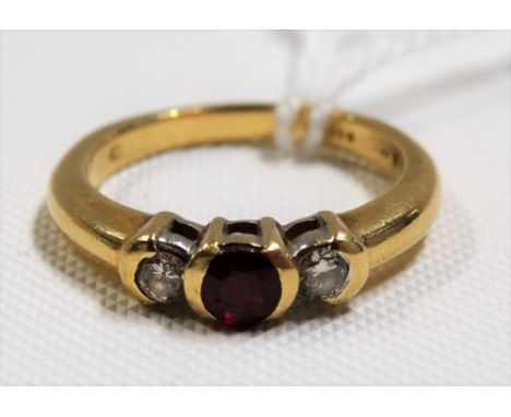Modern 18ct diamond &amp; ruby three stone ring, the two diamonds of 0.7ct spread approx, weight 5.3g approx
