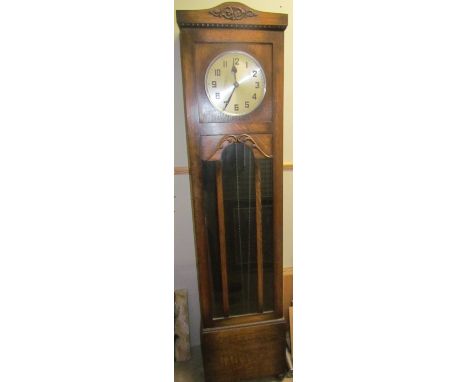 A 20th century oak long case clock, with a silvered dial and Arabic numerals and a glazed trunk door