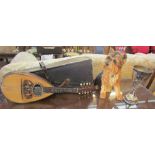 A bowl back eight string mandolin, inlaid with mother of pearl,