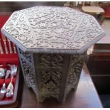 An Anglo Indian hardwood occasional table with an octagonal top and base carved with flowers and