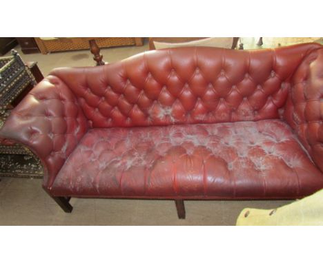 A red leatherette three piece suite with button back upholstery on square legs