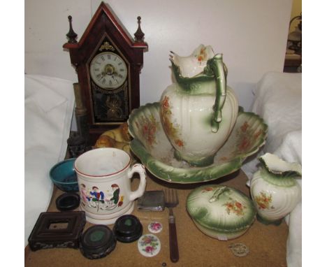 A 19th century steeple clock together with a pottery wash basin set, pottery lions, pottery mug etc