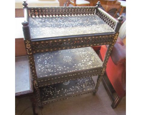 An Anglo Indian mother of pearl inlaid three tier side cabinet, with a turned three quarter gallery top