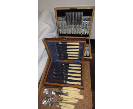 An electroplated and mother of pearl fruit set, cased together with another cased fruit set and loose flatwares