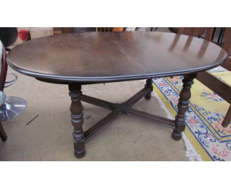 An Ercol dark elm extending dining table