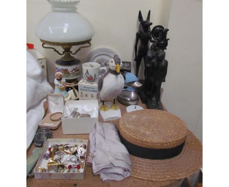 A table lamp with a hunting scene together with Egyptian figures, puffin figure, hat, Wedgwood children's china, silver bangl