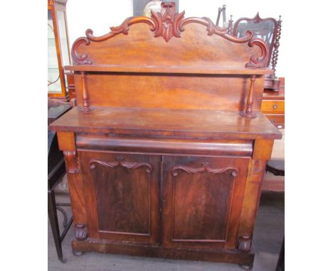 A Victorian mahogany chiffonier with a raised superstructure and shelf, the base with a frieze drawer and a pair of cupboard 